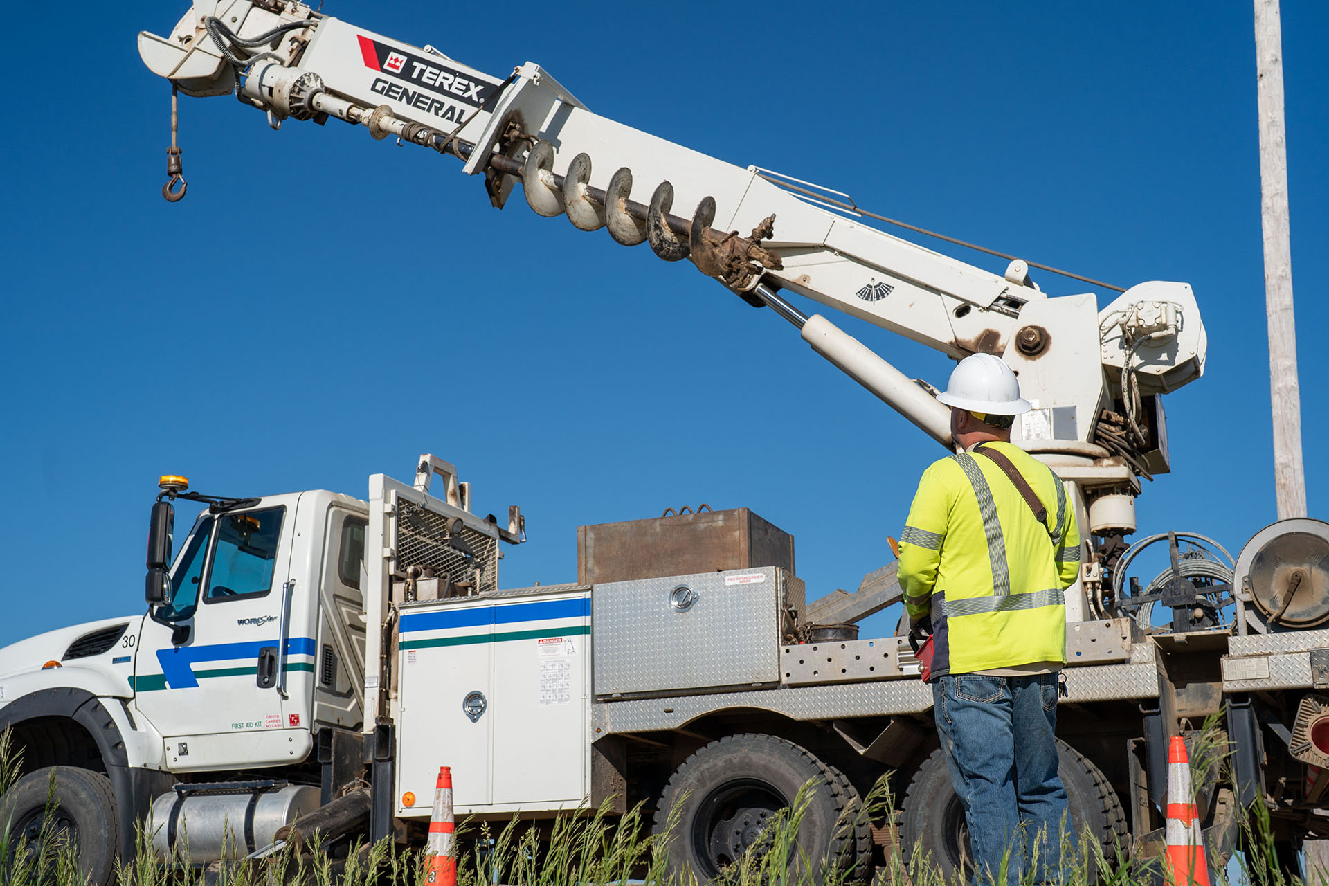 Utility worker operating a Terex digger derrick