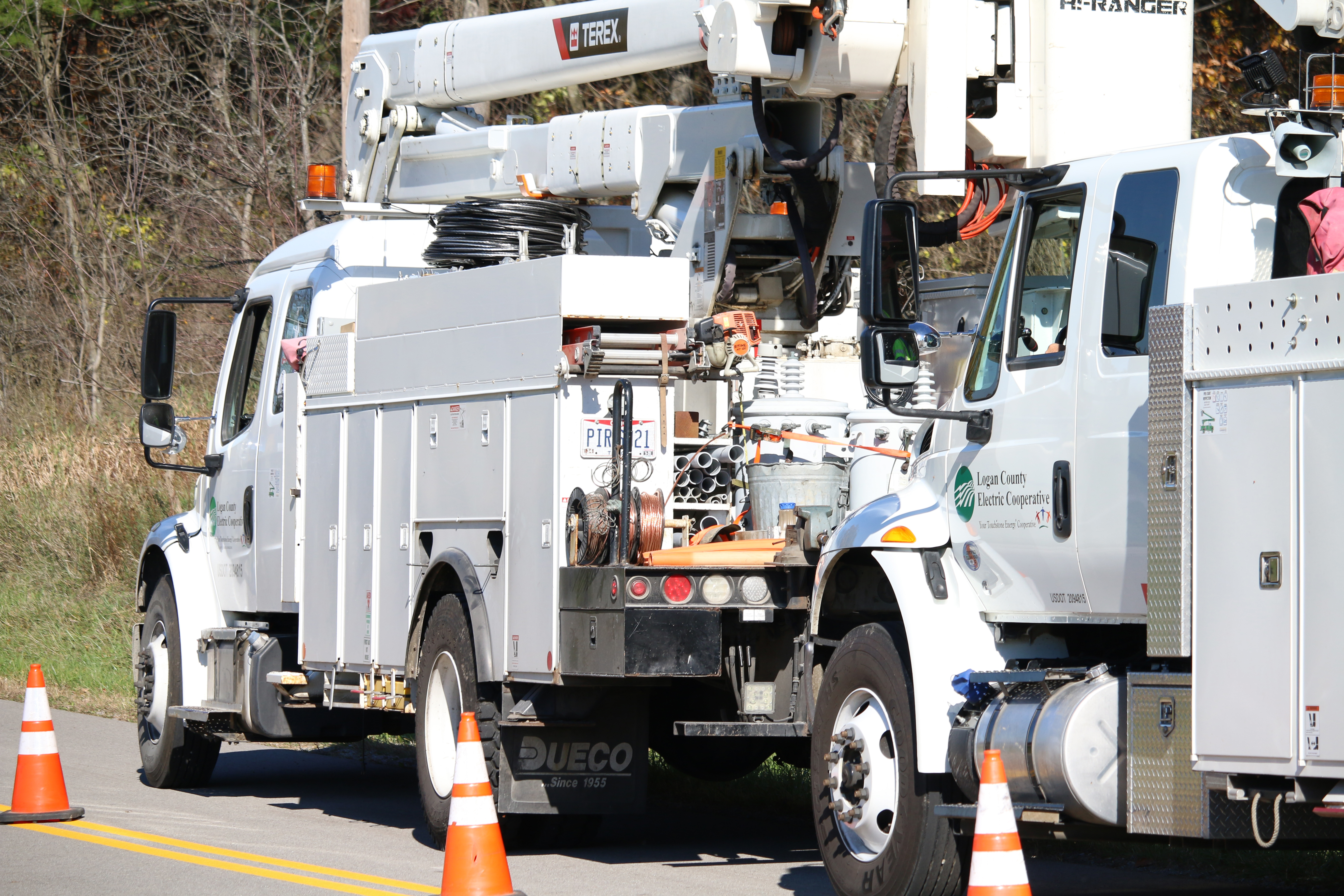 Terex bucket trucks parked on the side of a road