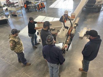 Participants of a Terex Maintenance Workshop learn about the components of a Terex bucket truck