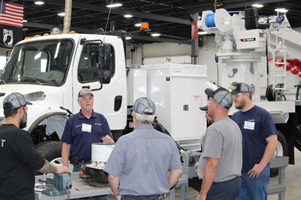 Mechanics listening to Terex training for bucket trucks and digger derricks