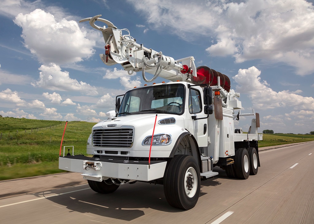 Terex Commander Digger Derrick driving down highway