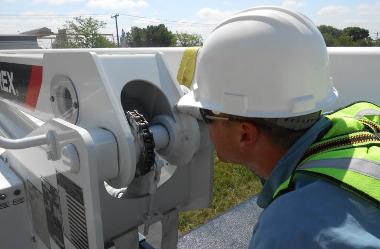 Utility worker inspecting Terex bucket truck
