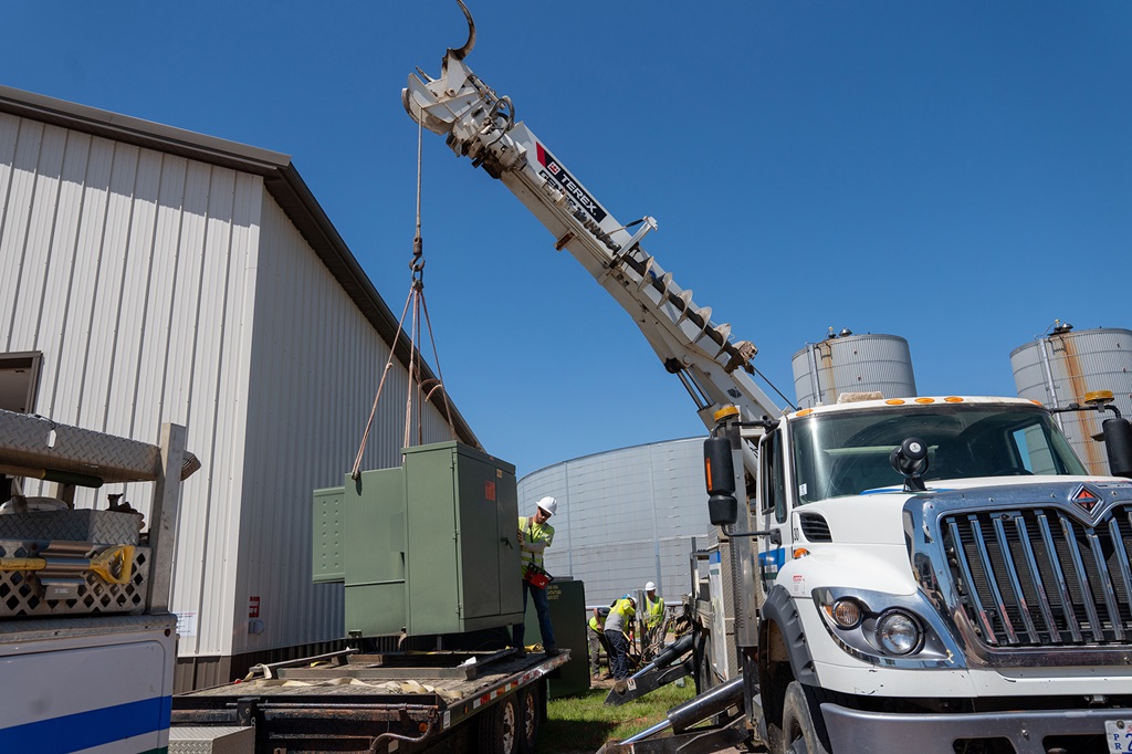 Terex digger derrick lifting a padmount transformer