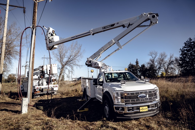 Terex TRX Series telescopic bucket trucks working on power line