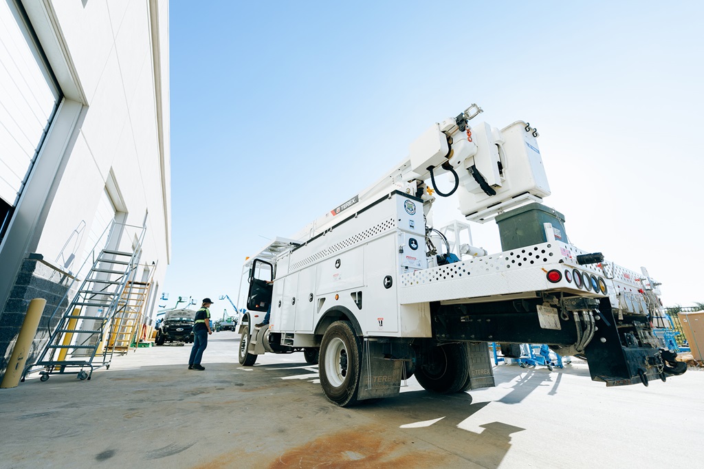 Technician standing next to Terex bucket truck