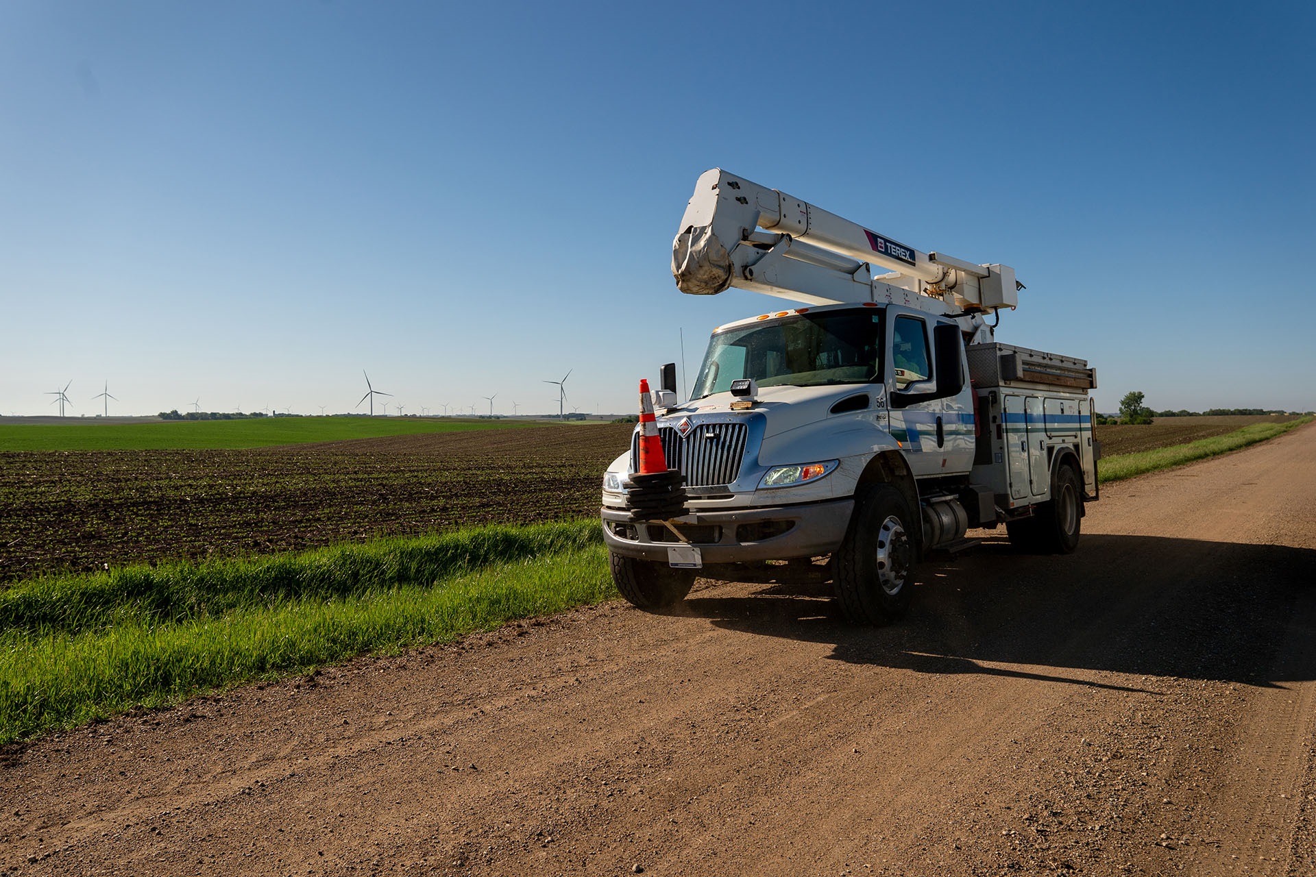 Terex Hi-Ranger HR46 bucket truck driving down gravel road
