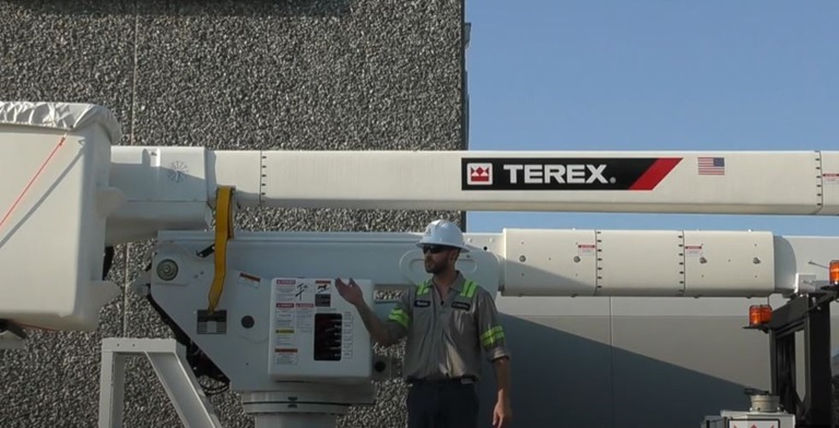 Technician demonstrating operation of Terex bucket truck